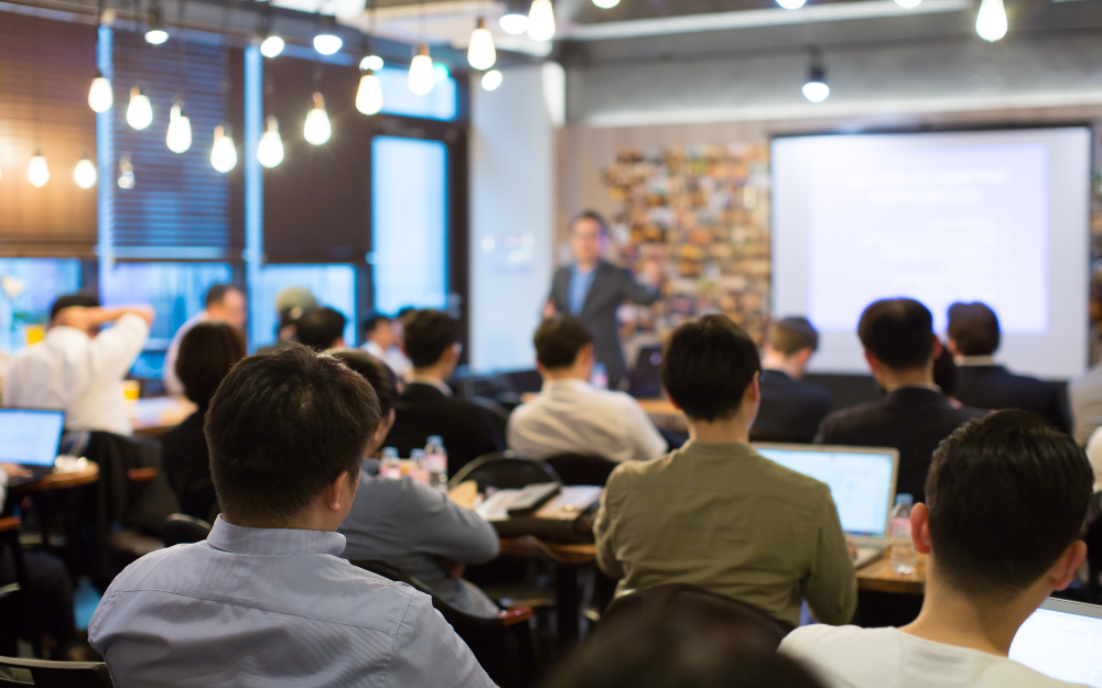 An image showing a group of future real estate agents attending a presentation.